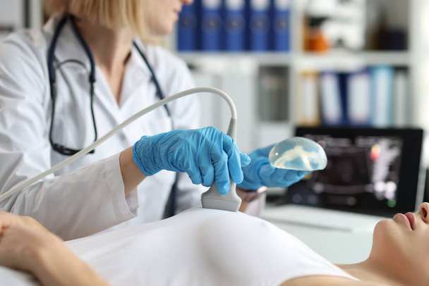 Médico segurando implante e fazendo exame de ultra-som de seios de mulher close-up - Foto, Imagem