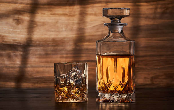 Closeup of scotch whiskey or rum with ice cubes - Фото, изображение