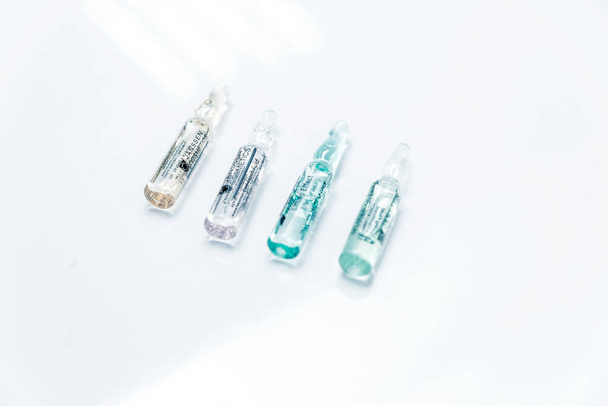 Glass beauty ampoule with concentrated essence inside on white background- Minsk, Belarus- August 20, 2021. Horizontal photo - 写真・画像