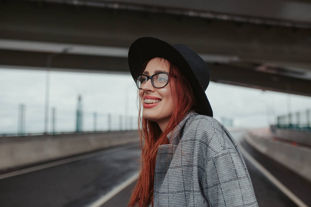 young woman with red hair laughing with braces - Foto, Bild