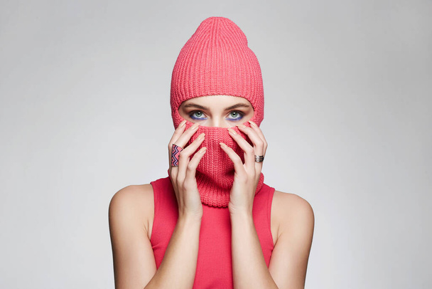 beautiful girl in red balaclava. New Hat style. Trendy Pink Mask on pretty woman - Photo, Image