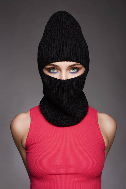 beautiful girl in black balaclava. Trendy Mask on pretty woman. New Hat style - Valokuva, kuva