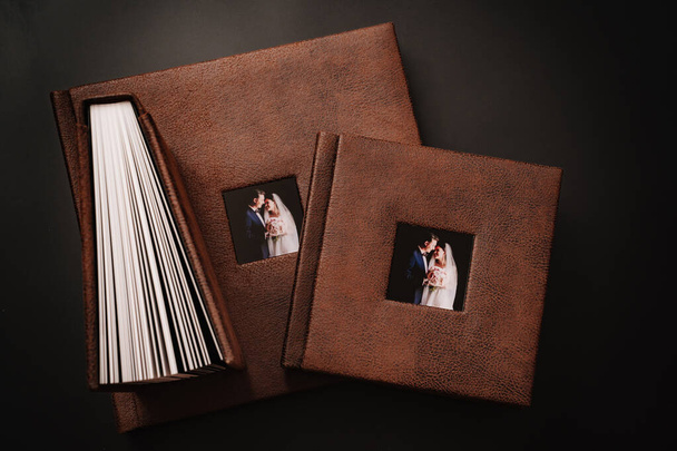 wedding photobooks in brown leather binding with photos on the cover - Foto, Imagem