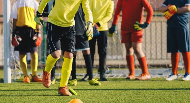 Young Soccer Goalkeepers at Training Unit. Boy Soccer Players Improving Speed Skills. Kid Goalkeeper in a Practice Session. Footballer Running Through Row of Cones - Photo, Image
