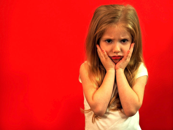 The child is in a bad mood. Child girl is upset. The girl was offended. Negative emotions. - Photo, Image