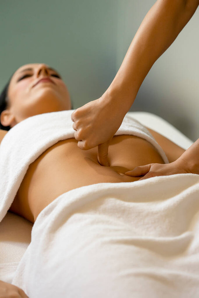 Stomach massage in health center - 写真・画像