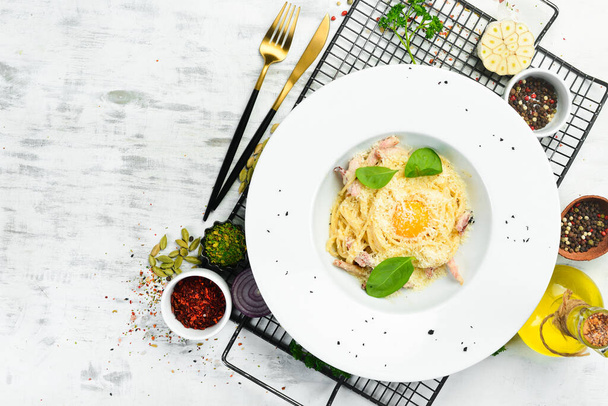 Pasta carbonara with egg yolk. Italian cuisine. Menu. Top view. - Foto, imagen