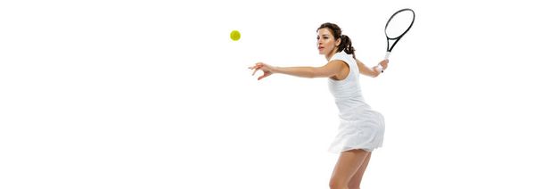 Dynamic portrait of young sportive woman, tennis player practicing isolated on white background. Healthy lifestyle, fitness, sport, exercise concept. - Foto, Imagen
