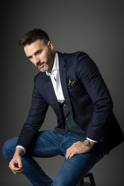 Pensive man wearing jeans and jacket - Photo, Image