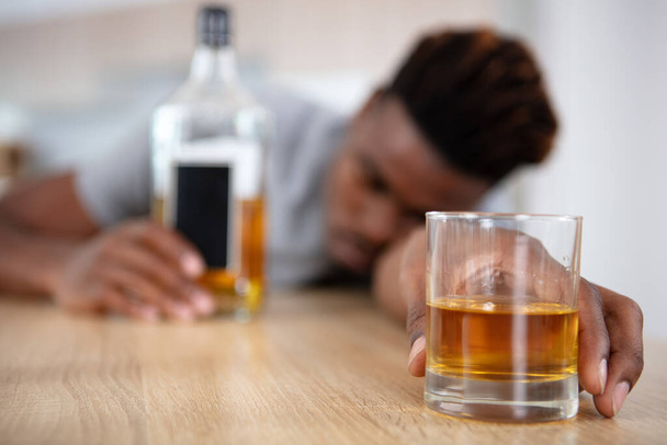 alcohol addicted man sleeping at the table - Фото, изображение