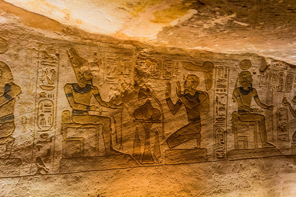 ABU SIMBEL, EGYPT - FEB 22, 2019: Wall carvings in the Great Temple of Ramesses II  in Abu Simbel, Egypt. - Фото, изображение