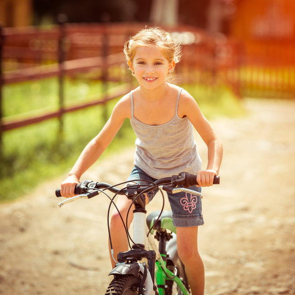 little girl riding a bicycle - 写真・画像
