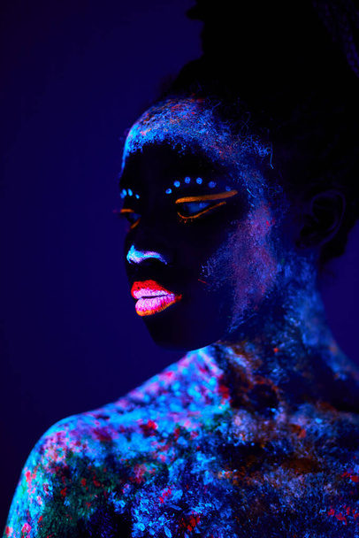 Portrait of an attractive young female model in bright blacklight bodyart - Foto, Imagem