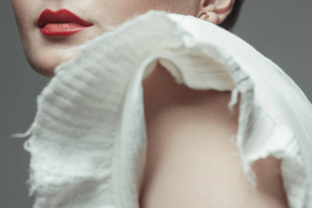 Body part concept. Portrait of beautiful young woman with perfect skin and natural make-up posing over gray background. Red lips, white dress. Classic style. Close up. Studio shot - Φωτογραφία, εικόνα