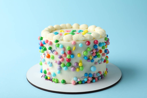 Cute bento cake with tasty cream on light blue background - Foto, Imagen