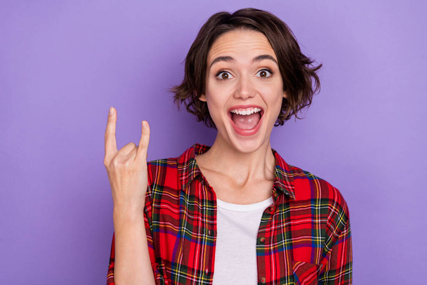 Photo of funny young bob hairdo lady yell show rock sign wear red shirt isolated on purple color background - Fotoğraf, Görsel