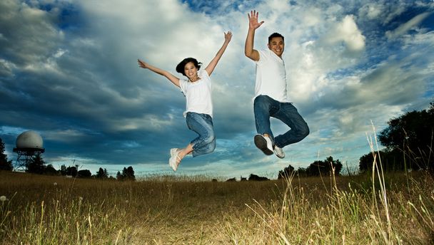 Asian couple jumping in joy - Foto, Imagen