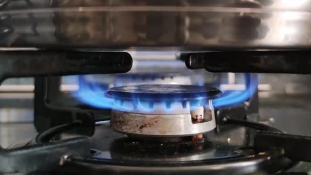 Vista ravvicinata di un bruciatore a gas su cui viene riscaldata una pentola  - Filmati, video