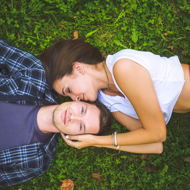 Couple lying on grass - Foto, afbeelding