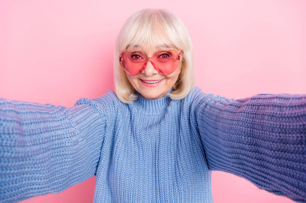 Self-portrait of attractive cheerful grey-haired woman wearing specs valentine day isolated over pink pastel color background - Fotó, kép