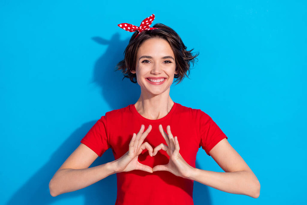Photo of young cheerful woman show fingers heart symbol romantic cupid isolated over blue color background - Foto, Imagen