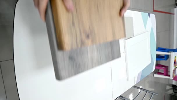 Home improvement concept. Girl the designer chooses the facades and handles for cabinet furniture in a store showroom. decors boards on the furniture industry. Choosing samples of materials. - Footage, Video