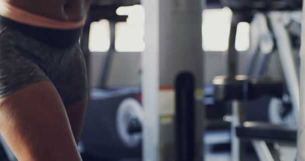 Heels off, gloves on. 4k footage of a woman working on her boxing routine at the gym. - Photo, Image