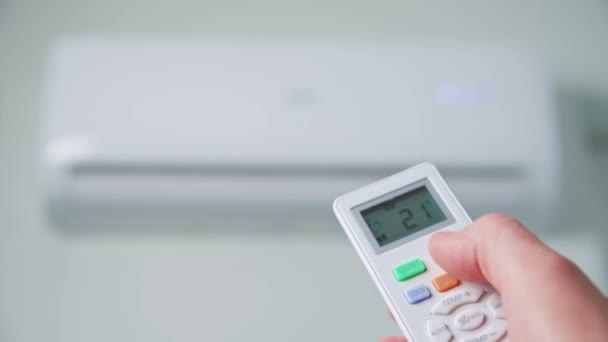 Hand adjusting temperature on air conditioner - Felvétel, videó