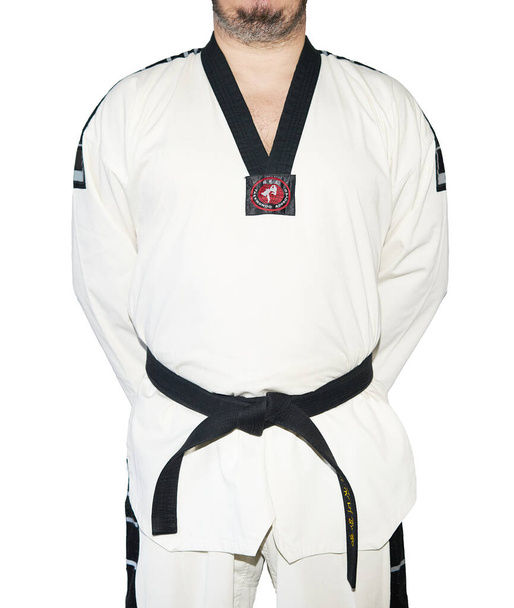 Egy taekwondo harcművészeti egyenruhás férfi. - Fotó, kép