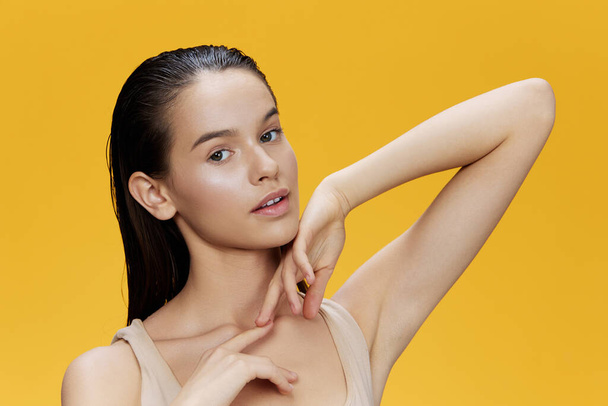 young woman clean face skin care yellow background - Valokuva, kuva