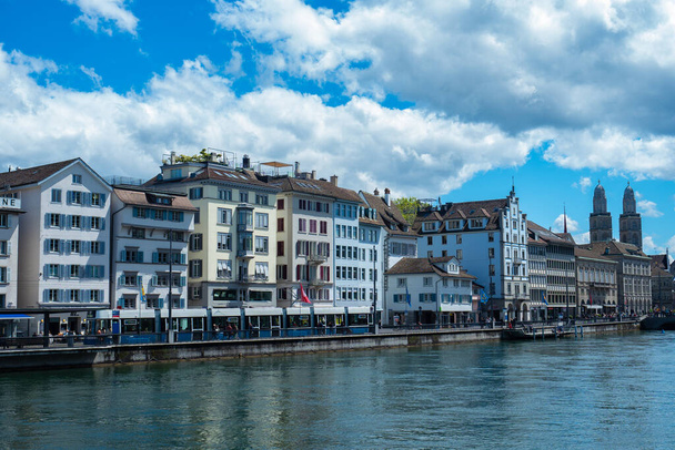 Zurich, Switzerland - May 23rd 2021: Historic city centre at the waterfront of the Limmat river. - Photo, Image