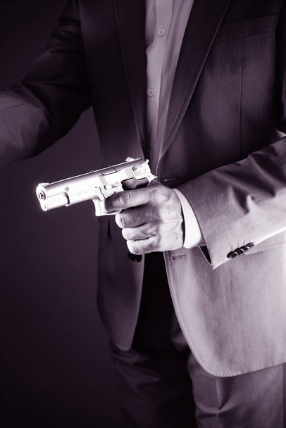 Retro secret agent with pistol revolver gun in hand in vintage crime thriller mockup cover     photo.        - Fotografie, Obrázek