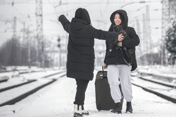 Meeting of two young women at the railway station. Train travel - Φωτογραφία, εικόνα