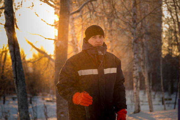 Portrait of a male assembler at the workplace in winter overalls - Photo, Image