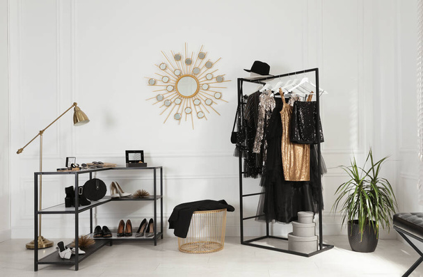Stylish dressing room interior with trendy clothes, shoes and accessories - Foto, immagini
