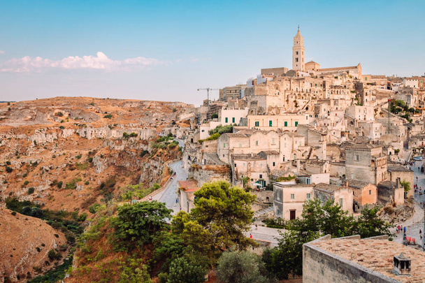 Matera, Italy - August 2021: Sassi di Matera from the Belvedere Colombo (Church of Sant'Agostino), blue sky with clouds - Фото, изображение