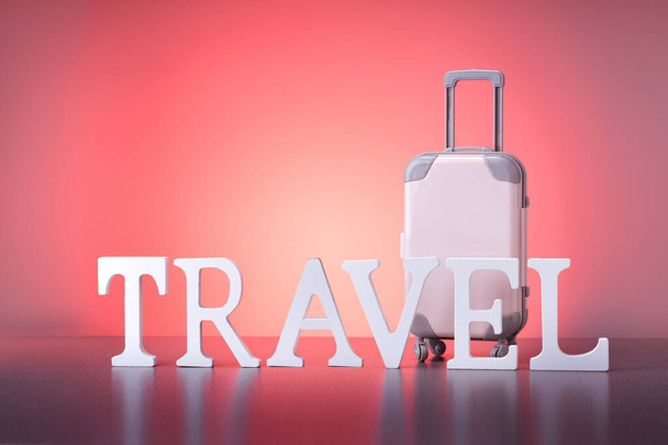 Word TRAVEL with suitcase on red background with copy space. Travel concept. - Fotó, kép