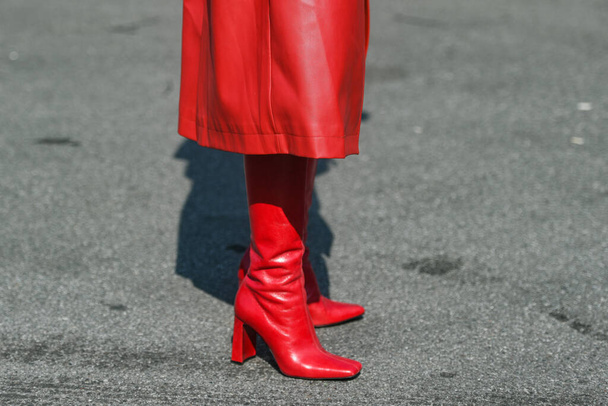 Street style outfit - woman wearing red boots and long leather red skirt - Photo, image
