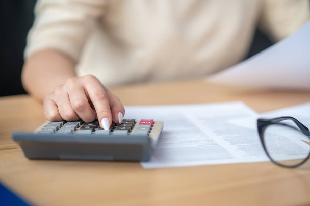 Bookkeeper calculating financial budget at the office desk - Photo, image