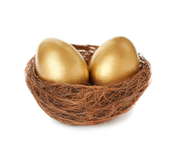 Shiny golden eggs in nest on white background - Foto, Imagem