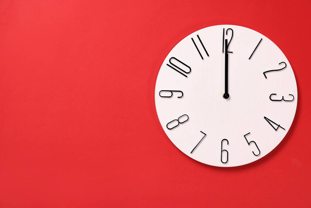 Modern clock on red background, top view. Space for text - Foto, Imagen