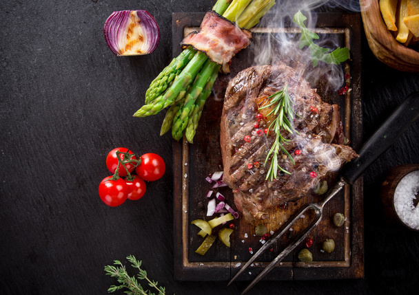Beef steak on wooden table - Foto, Imagen