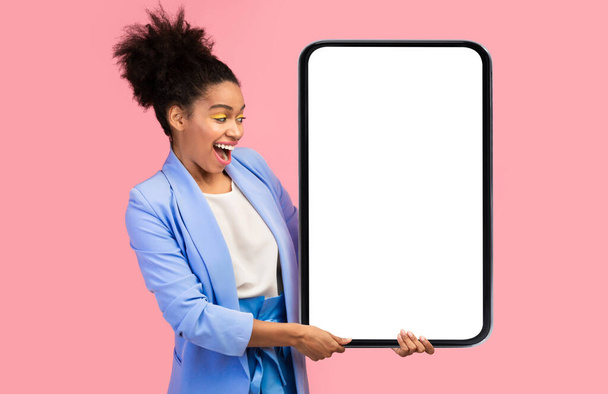 Excited African Woman Holding Big Smartphone Blank Screen, Pink Background - Photo, Image