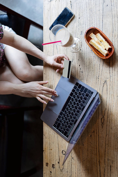Pretty young asian business woman using laptop in modern cafe.  - Photo, Image