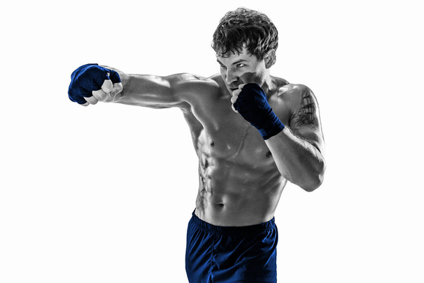 Studio shot of silhouette kickboxer who training practicing jab on white background. Blue sportswear - Fotografie, Obrázek