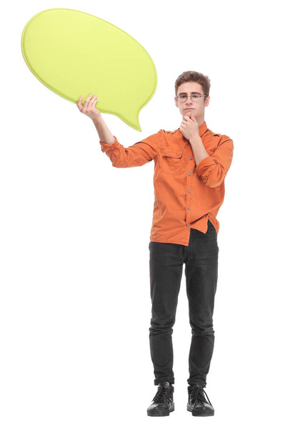 Attractive young man is holding a speech bubble, looking at camera and smiling - Фото, изображение