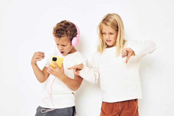 Image of boy and girl headphones with phone entertainment light background - Valokuva, kuva