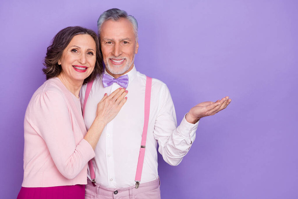 Portrait of two idyllic lovely partners embrace arm hold empty space isolated on purple color background - Foto, Bild