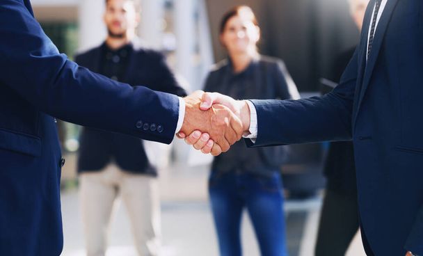 Congratulations, lets do this. Cropped shot of two unrecognizable businesspeople shaking hands while in the office during the day. - Photo, Image