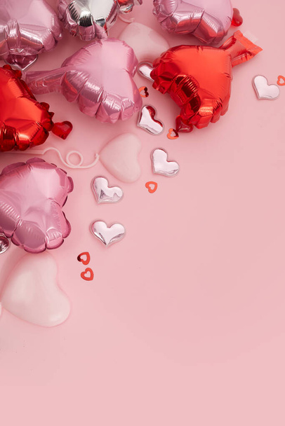 Romantic background for wedding, Valentines Day and birthday. Silver and pink heart-shaped balloons, confetti pink metal love heart. - Фото, зображення